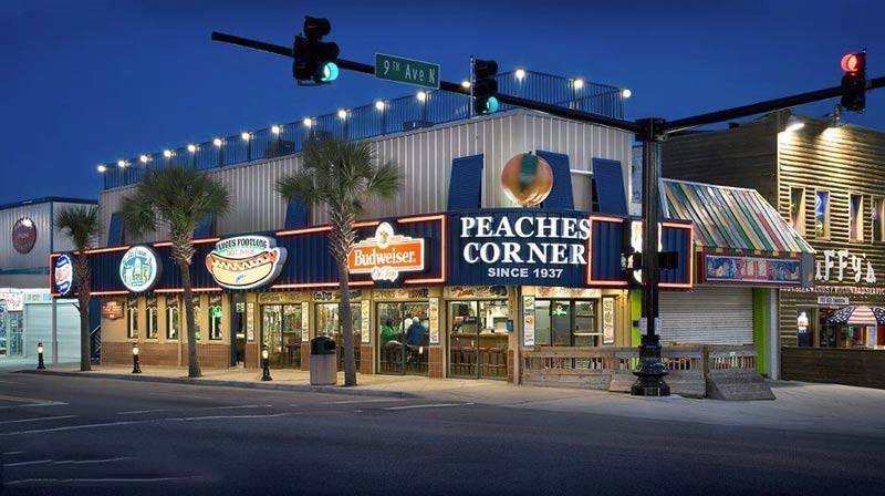 The exterior of Peaches Corner, bustling with visitors